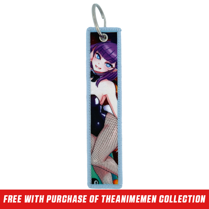 Keychain tag with anime-style purple-haired character, blue eye, and pink heart playing card design on light blue border.
